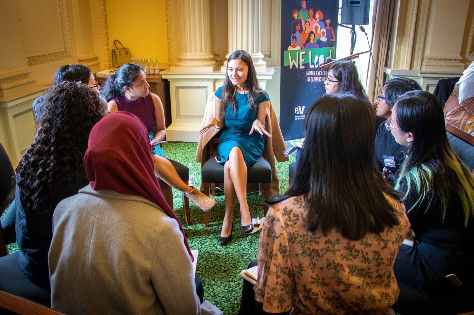 Yasmin Poole talking with a group of young women